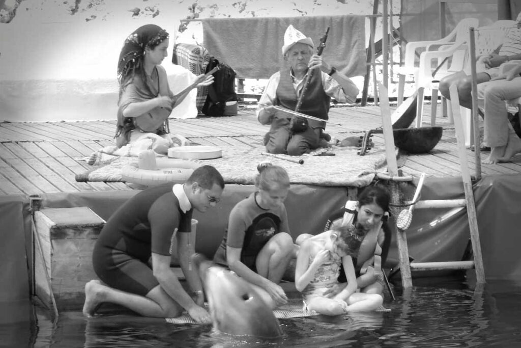 Rahmi Oruç Güvenç yunuslarla müzik terapi yaparken. 10 Haziran 2007, Kaş.